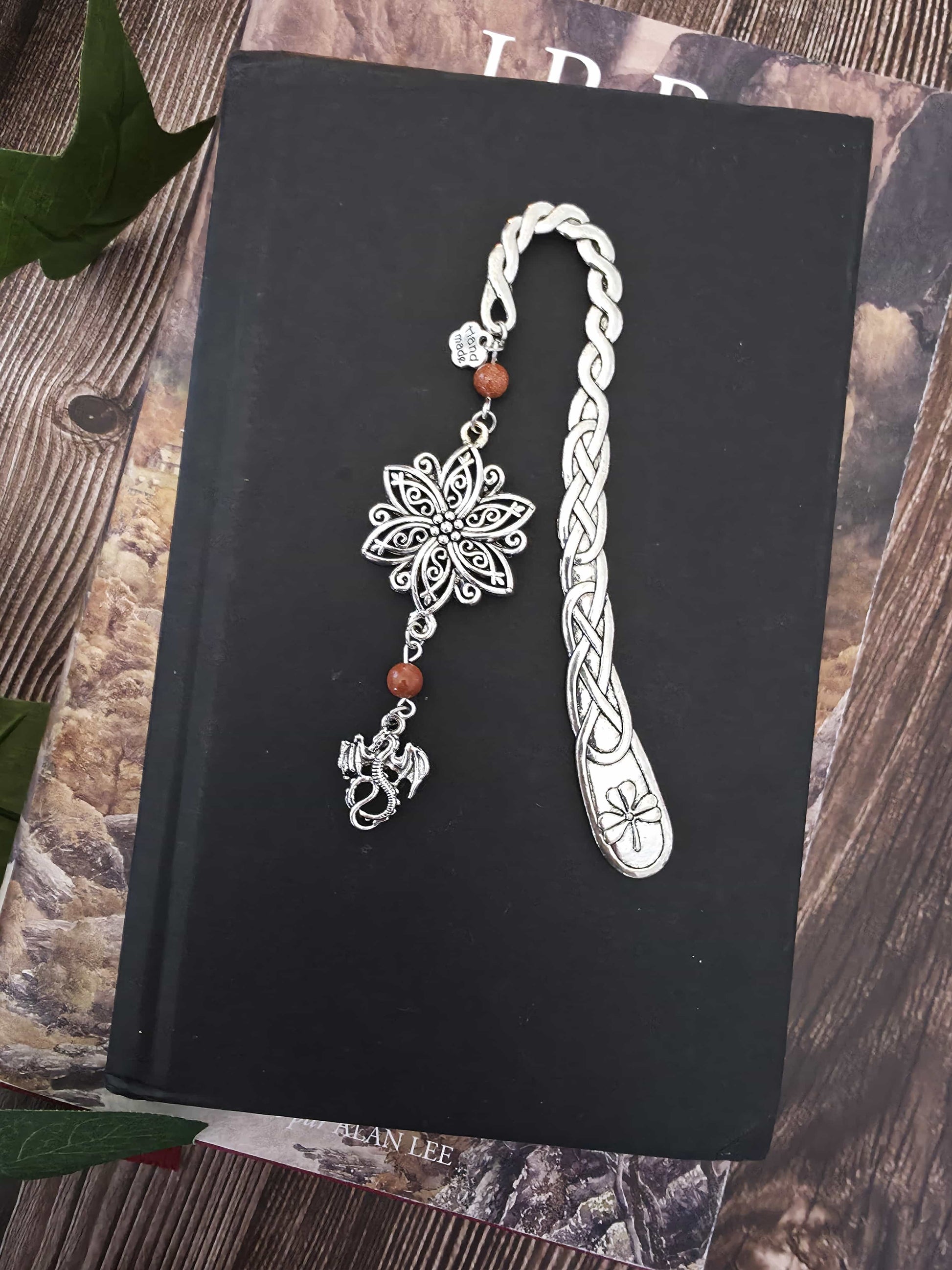 marque-page en métal en forme de petit dragon avec une grande fleur ciselé au dessus. Deux pierres naturelles de sable doré est sur le signet. Un bijou de livre original. Un cadeau pour lecteur de fantasy. Romantasy. Bellette Workshop