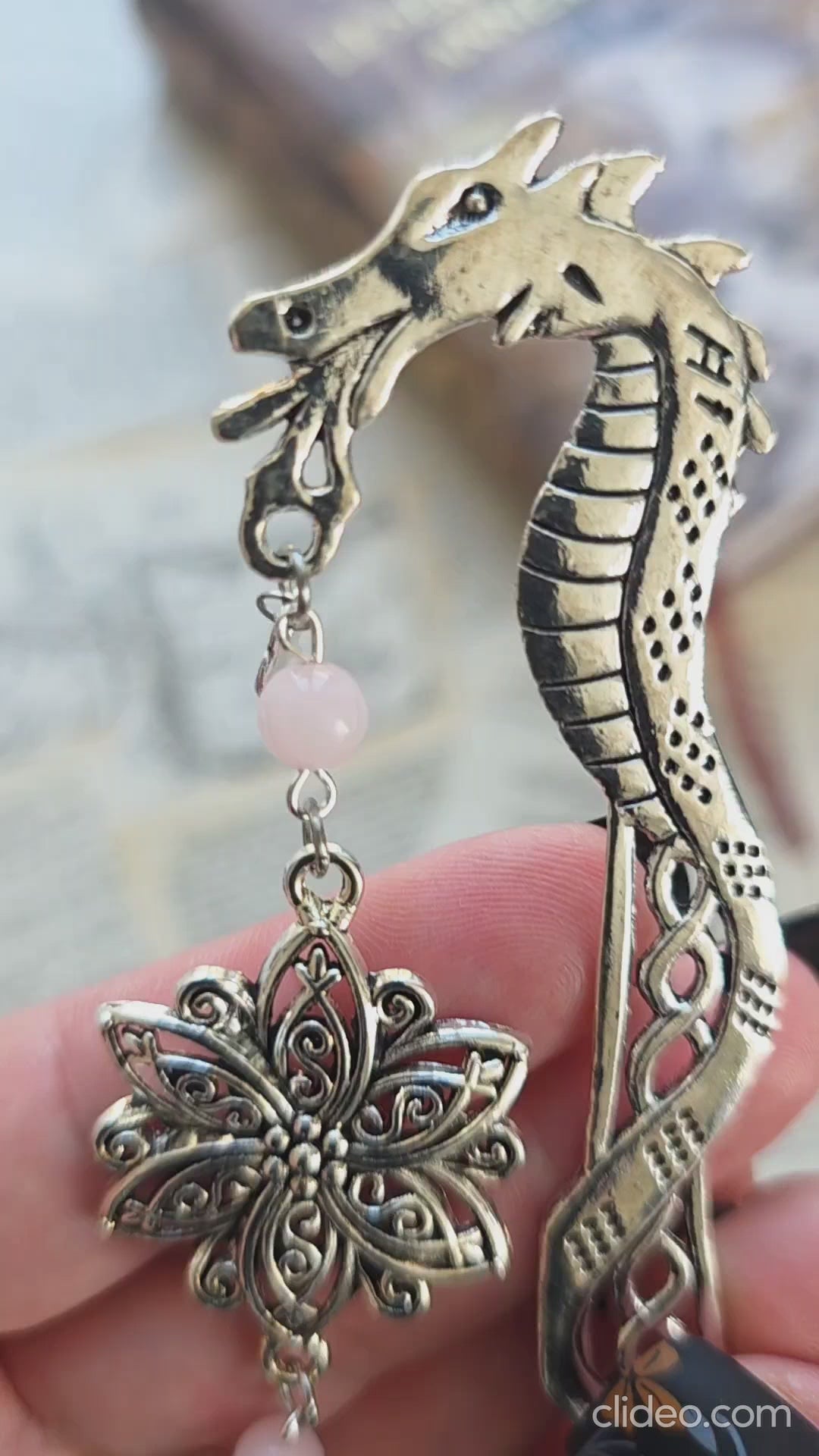 vidéo du marque page metal avec une tige dragon, une fleur ciselée, une épée et un coeur brisé. Pierres naturelles de quartz rose personnalisable. Bellette Workshop. Fait main. Metal bookmark fantasy. Dark fantasy. Amour brisé. Cadeau fait main original pour lecteur et lectrice 