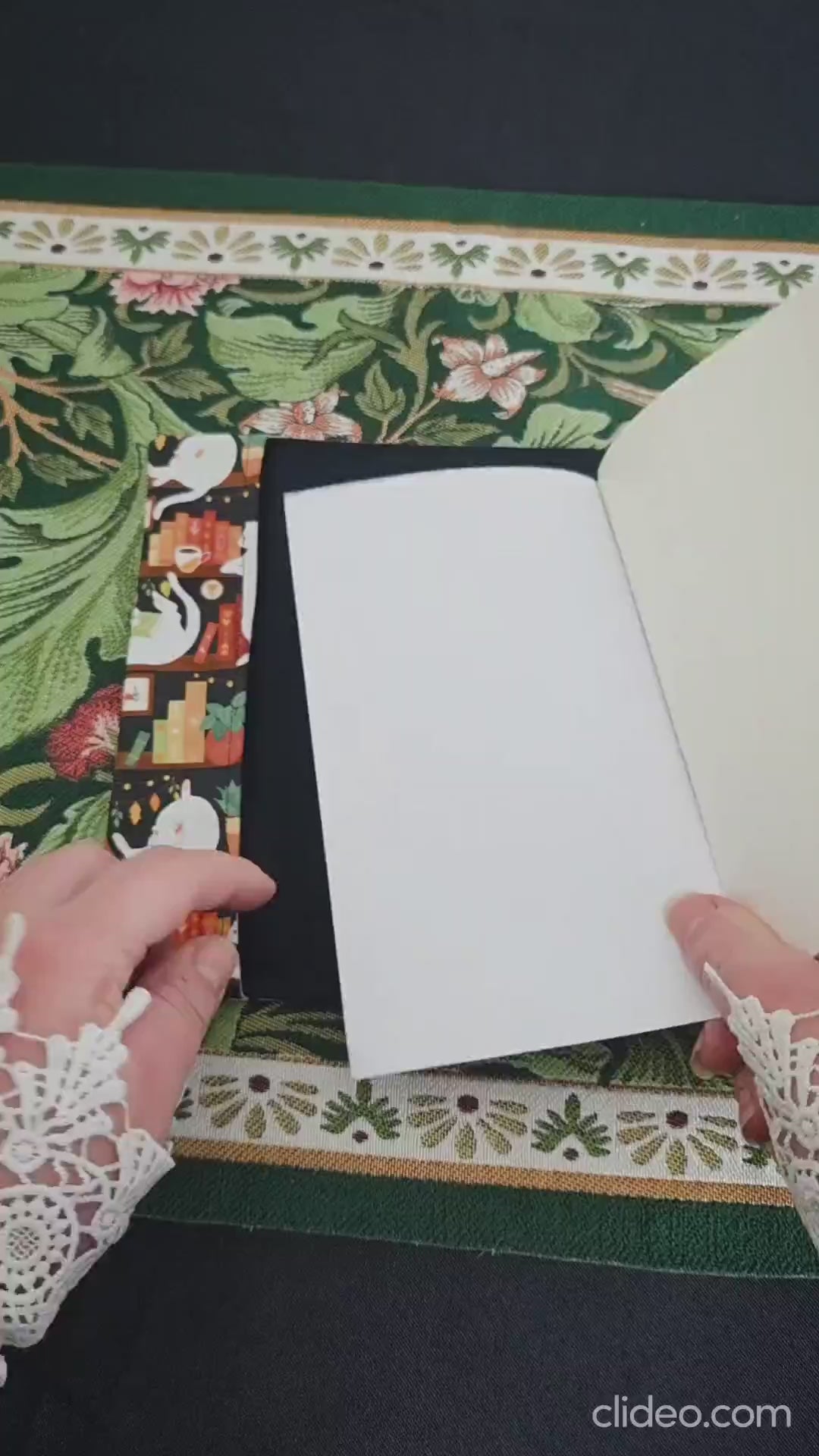 Vidéo de 10 secondes qui montre le couvre-livre artisanal ajustable aux nombres de pages et à l'épaisseur du livre. Motif tissu en coton chat bibliothèque avec son marque-page en tissu assorti. Bellette Workshop